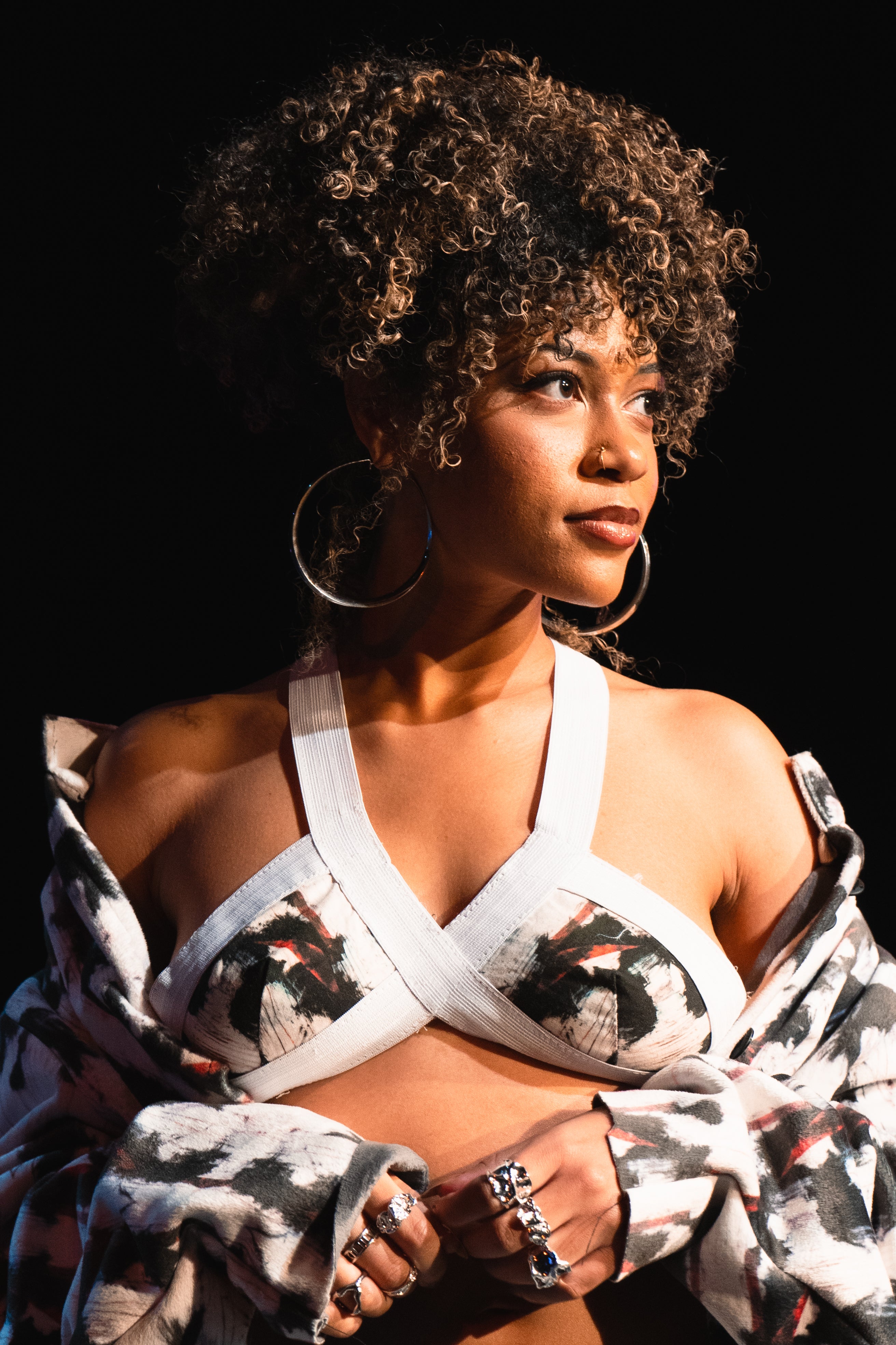 Woman wearing a patterned top with a black background