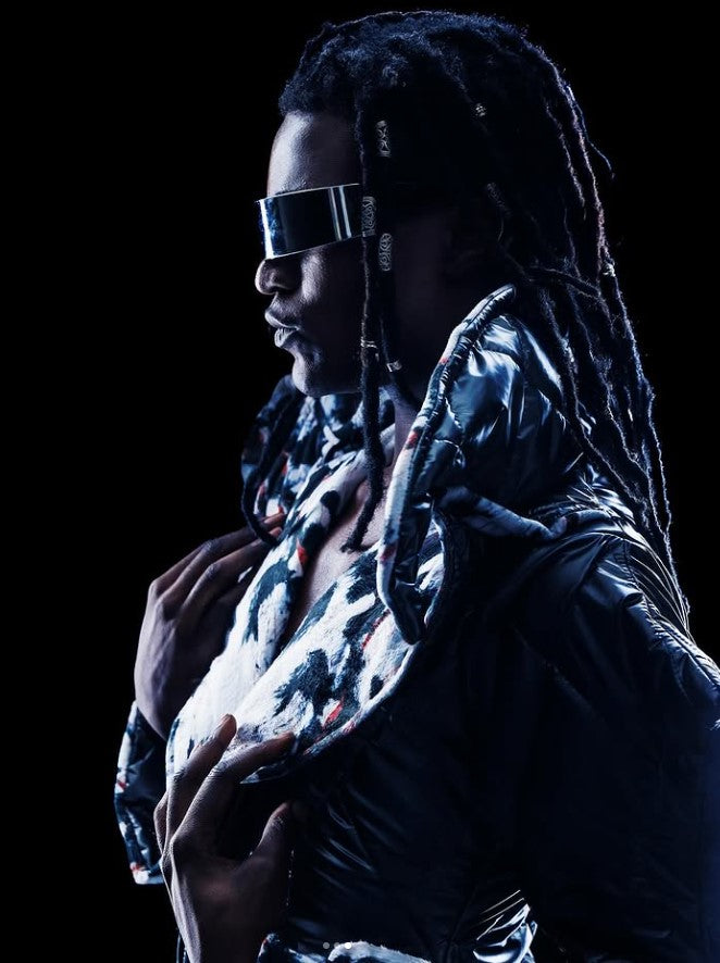 Person wearing a reflective jacket with a dark background