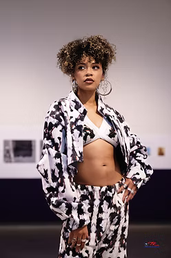Model wearing a black and white patterned outfit 