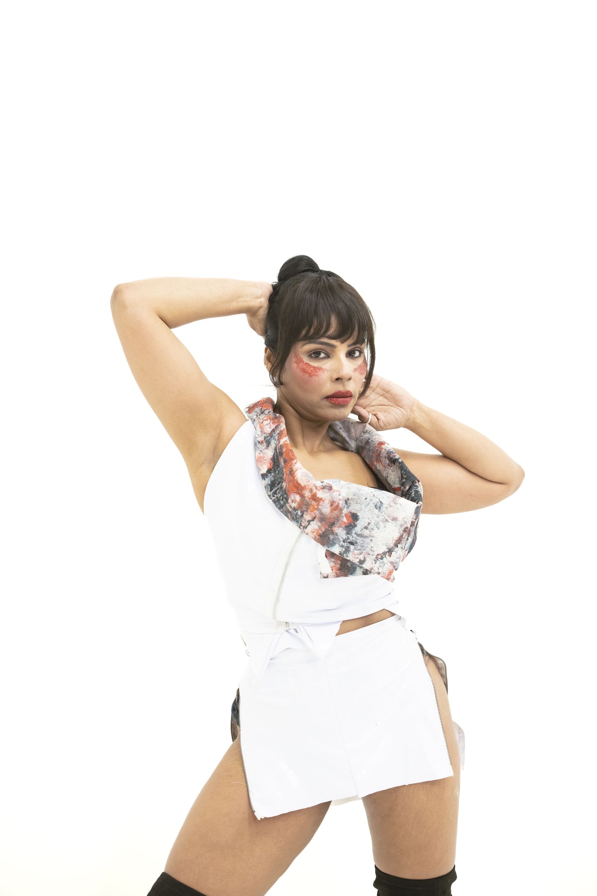 Woman wearing a white dress with floral patterns on a white background